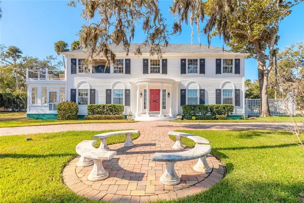 a view of a swimming pool with yard and tree s