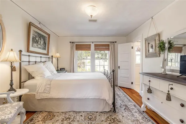 an aerial view of residential houses with outdoor space and lake view