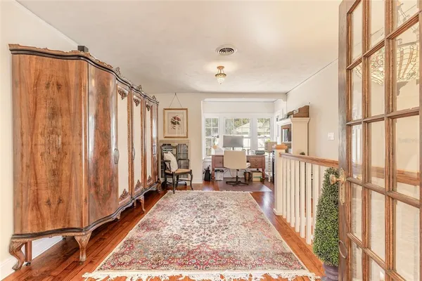 an aerial view of a house with swimming pool and large trees