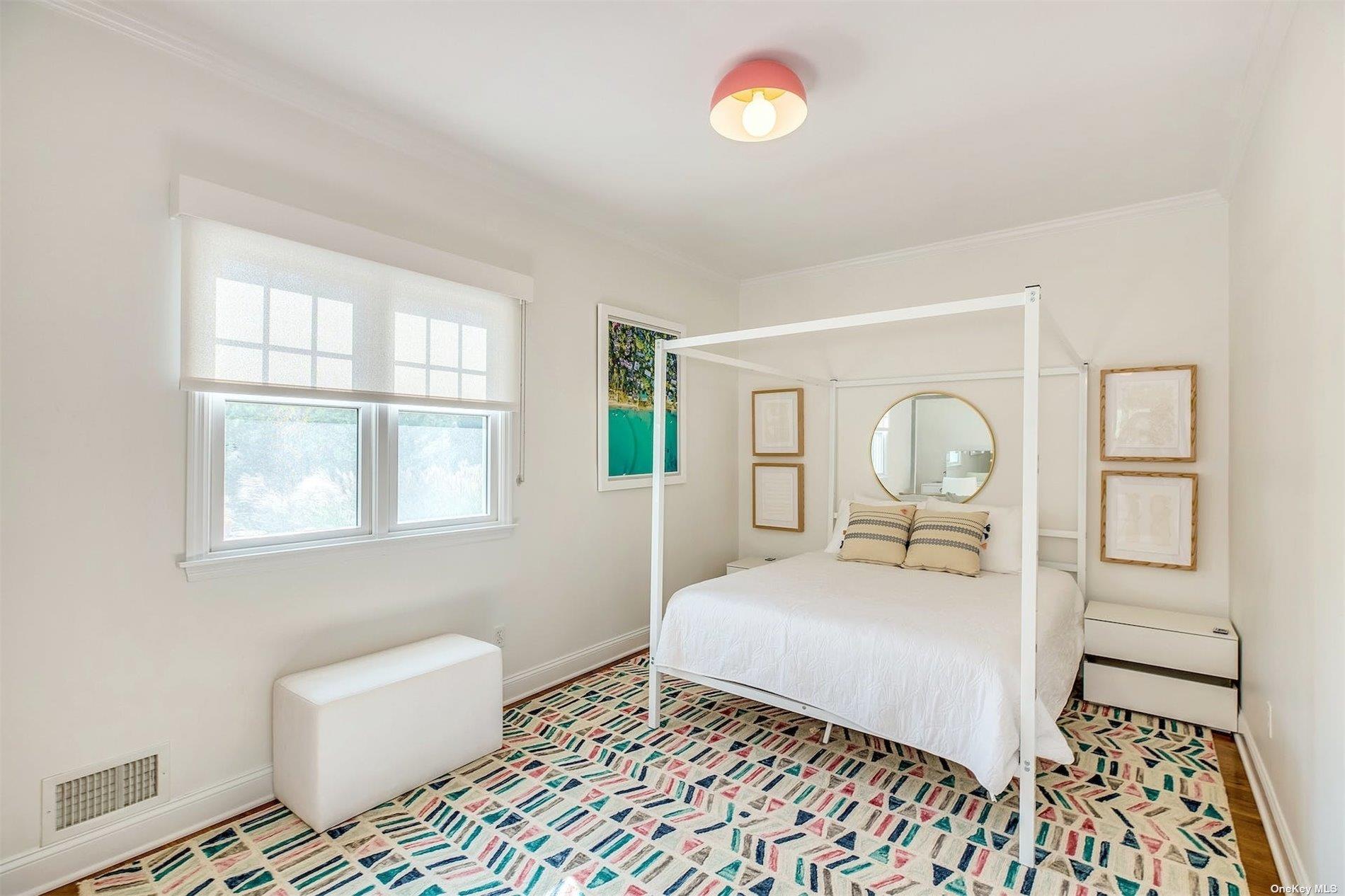25 Exchange Westhampton Beach, NY 11978 - Photo 11 of 31 a bedroom with a bed and a window