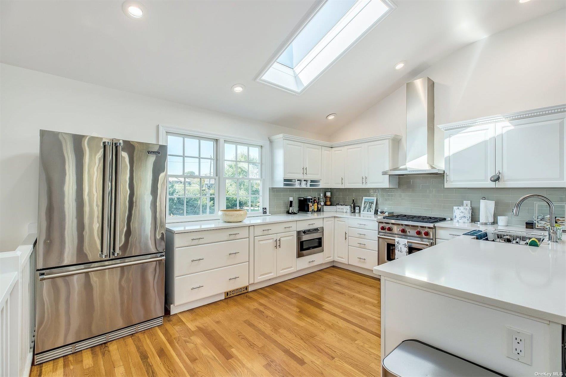 25 Exchange Westhampton Beach, NY 11978 - Photo 15 of 31 a kitchen with white cabinets and white appliances