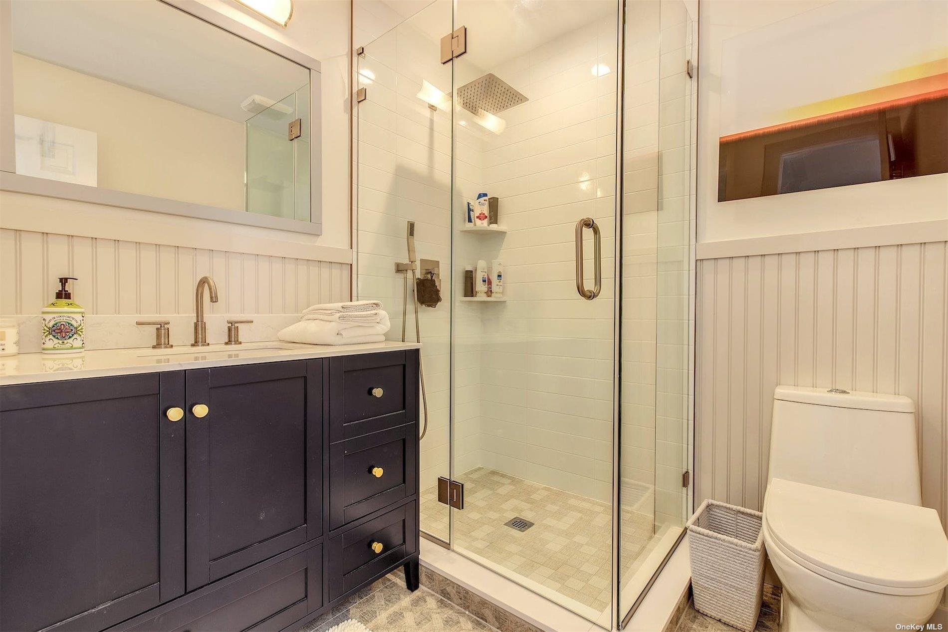 25 Exchange Westhampton Beach, NY 11978 - Photo 19 of 31 a bathroom with a sink a toilet and shower