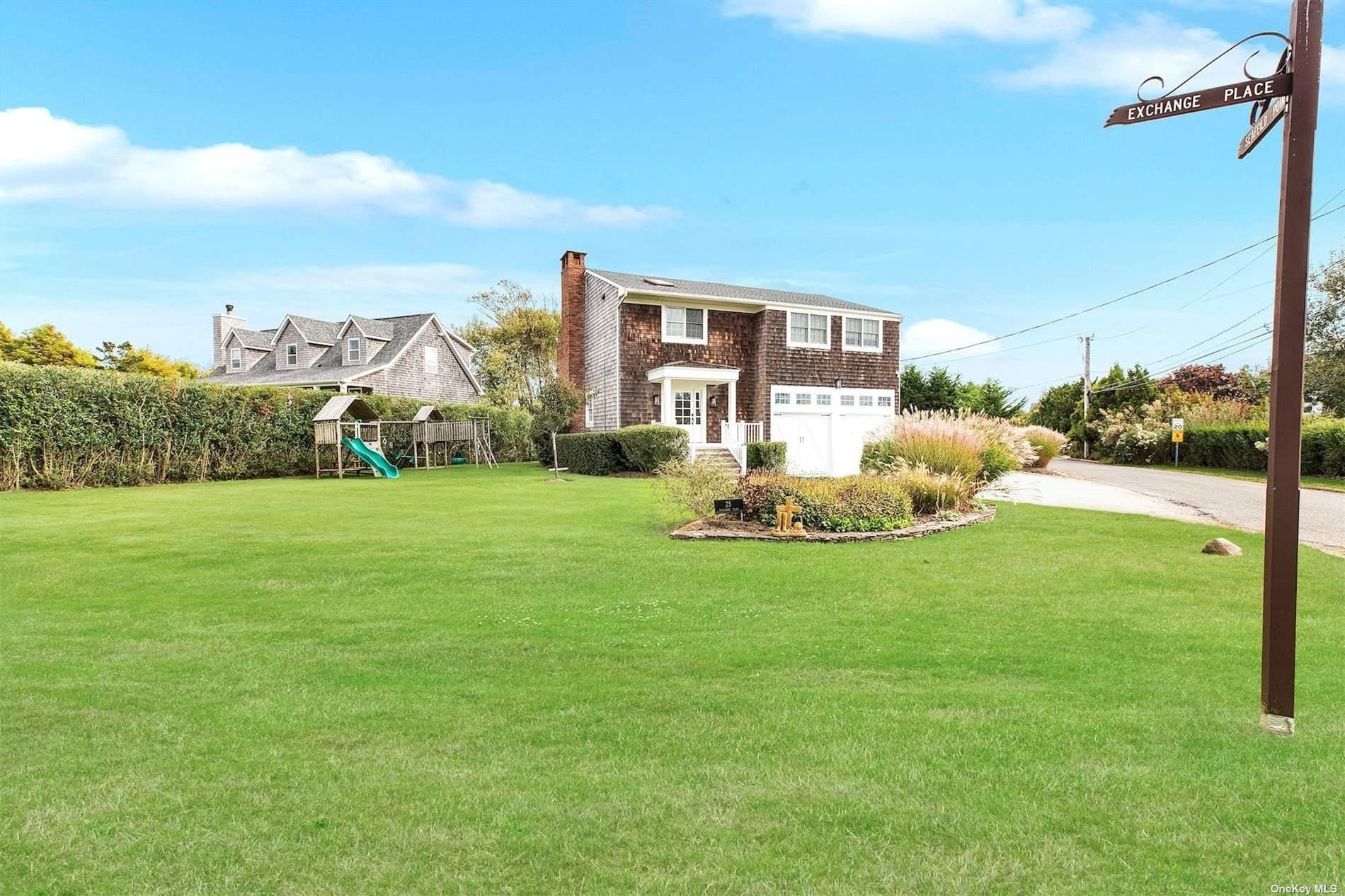 25 Exchange Westhampton Beach, NY 11978 - Photo 2 of 31 a view of a house with a yard table and chairs