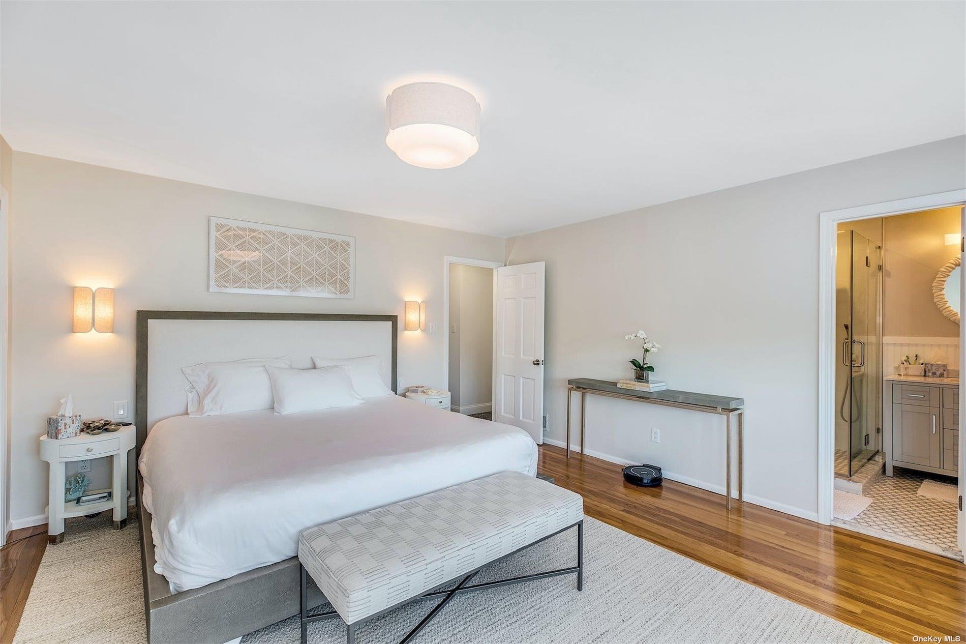 25 Exchange Westhampton Beach, NY 11978 - Photo 21 of 31 a bedroom with a bed and a lamp on table
