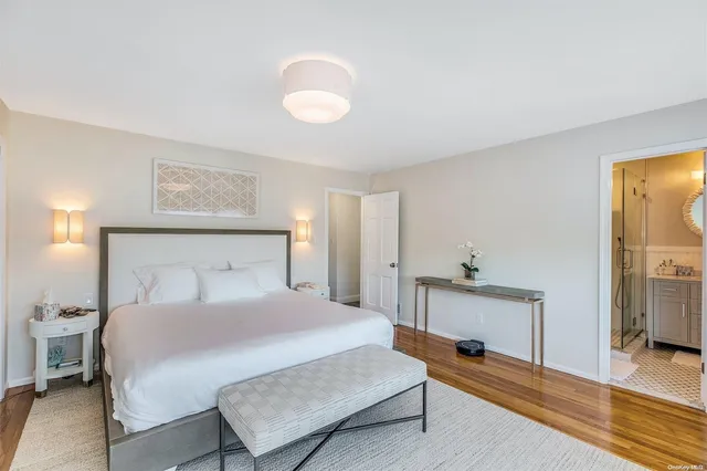 a bedroom with a bed and a lamp on table