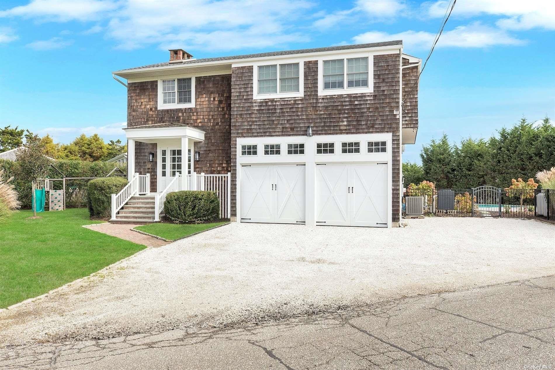 25 Exchange Westhampton Beach, NY 11978 - Photo 25 of 31 a front view of a house with a yard and garage
