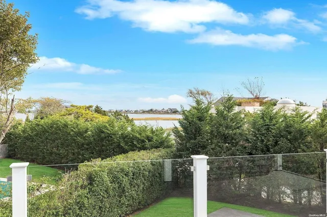 a view of a fence and trees in the background
