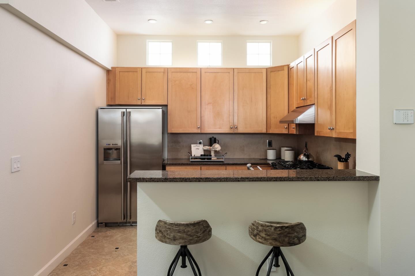 555 Front Lane Mountain View, CA 94041 - Photo 13 of 31 a kitchen with stainless steel appliances granite countertop a refrigerator a stove and white cabinets with wooden floor