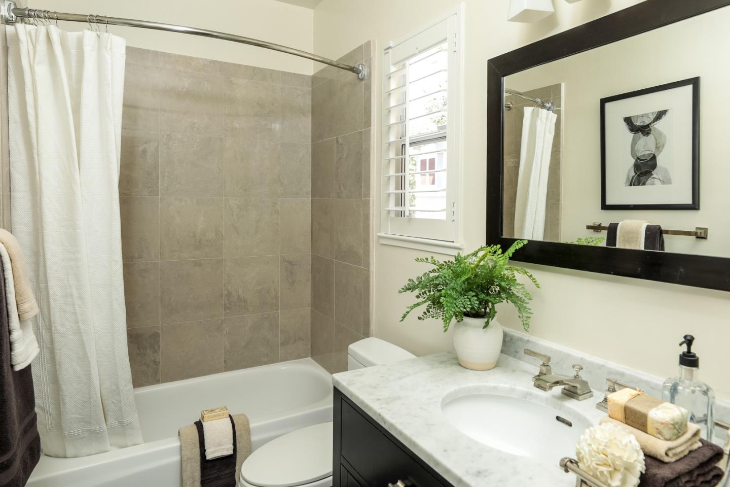 555 Front Lane Mountain View, CA 94041 - Photo 24 of 31 a bathroom with a granite countertop sink a toilet and a mirror