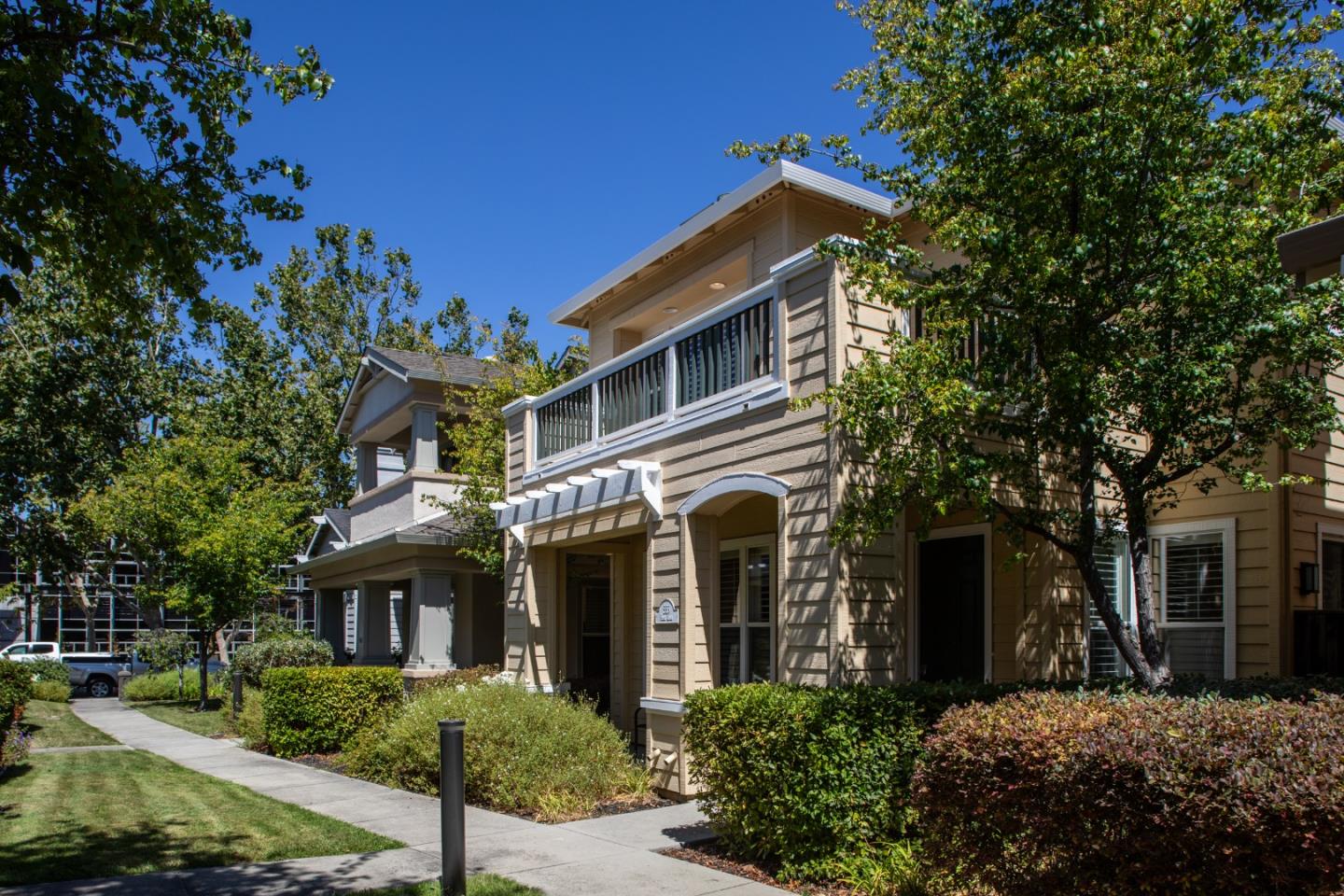 555 Front Lane Mountain View, CA 94041 - Photo 3 of 31 a view of a white house with large windows and a small yard