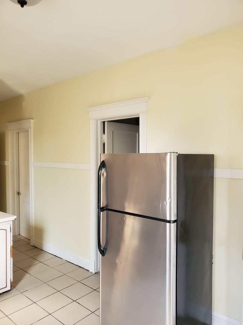 6221 South Laflin Street, Unit 2 Chicago, IL 60636 - Photo 13 of 20 a view of a refrigerator in kitchen and an empty room