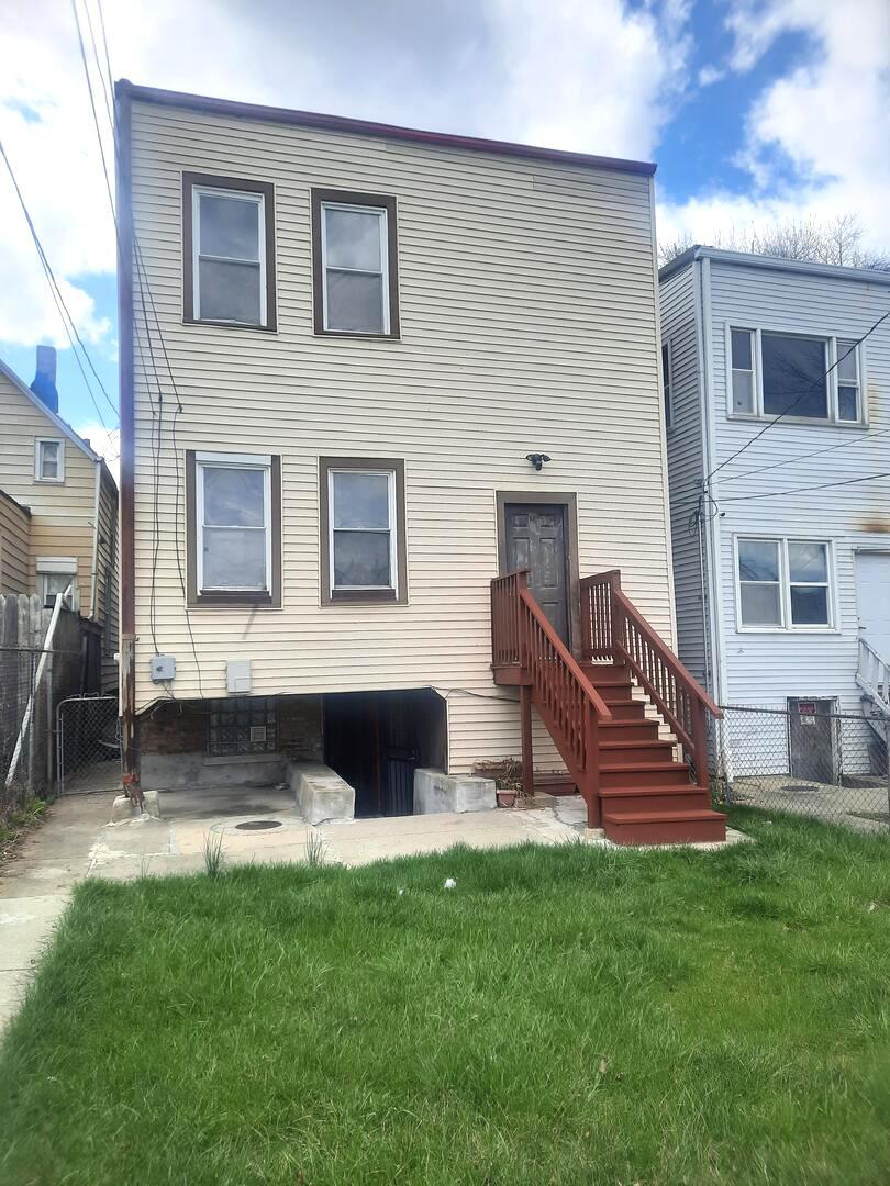 6221 South Laflin Street, Unit 2 Chicago, IL 60636 - Photo 17 of 20 a view of a house with a yard porch and wooden fence
