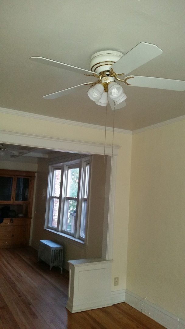 6221 South Laflin Street, Unit 2 Chicago, IL 60636 - Photo 8 of 20 a bedroom with a bed and a chandelier