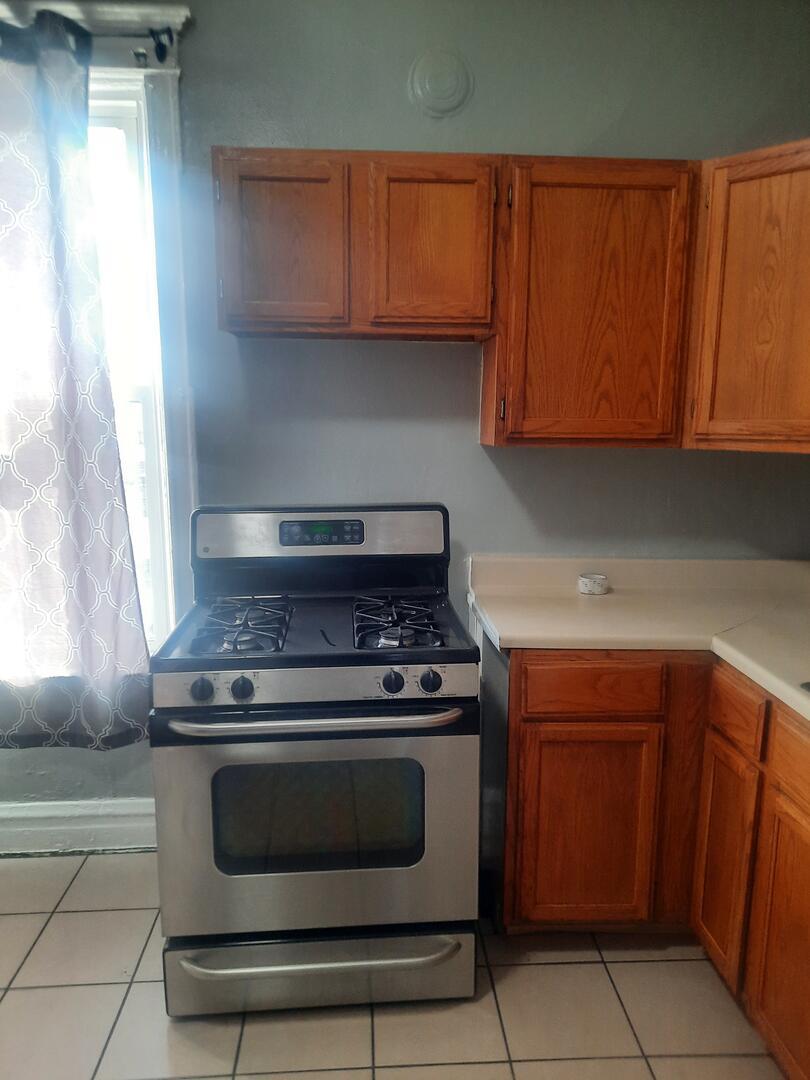 6221 South Laflin Street, Unit 2 Chicago, IL 60636 - Photo 10 of 20 a kitchen with a stove and a microwave