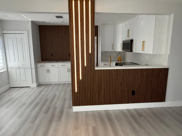 a view of hallway with wooden floor