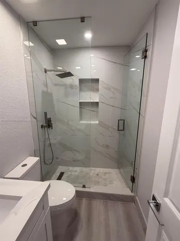 a bathroom with a shower and a toilet
