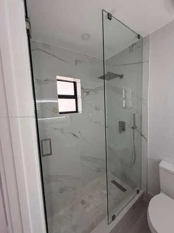 a bathroom with a shower and toilet
