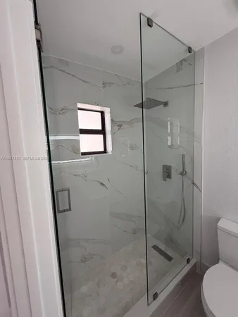 a bathroom with a shower and toilet