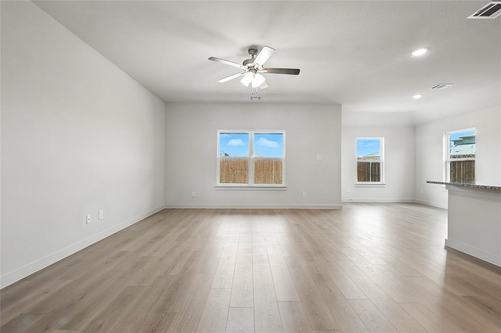 1795 Gleasondale Place Forney, TX 75126 - Photo 7 of 29 Unfurnished room with light wood-type flooring, ceiling fan, and recessed lighting