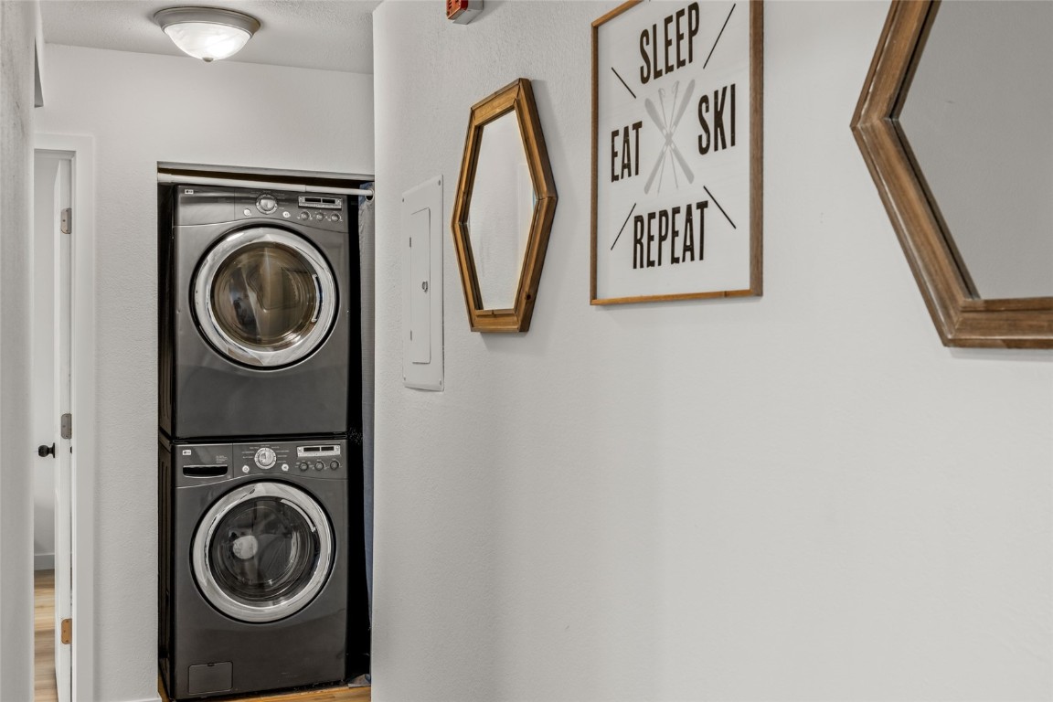1565 Shadow Run Frontage, Unit B103 Steamboat Springs, CO 80487 - Photo 17 of 28 a view of a hallway with washer and dryer