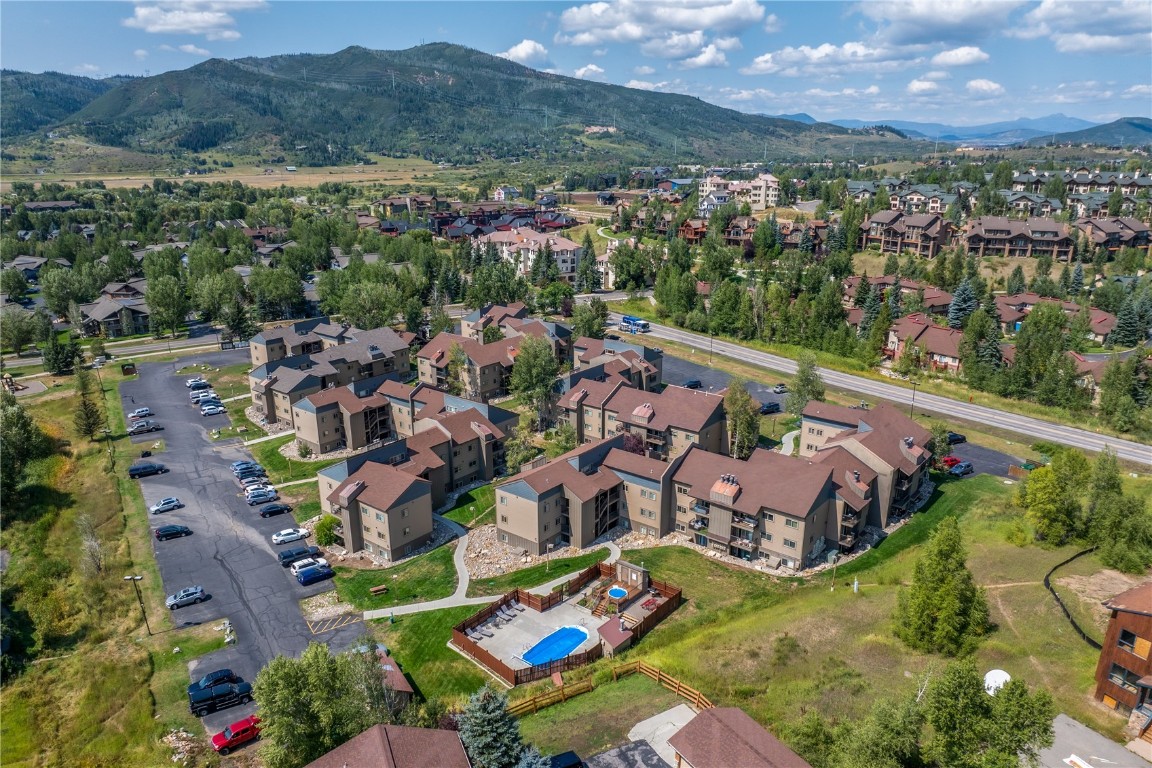 1565 Shadow Run Frontage, Unit B103 Steamboat Springs, CO 80487 - Photo 19 of 28 an aerial view of a city with lots of residential buildings ocean and mountain view in back