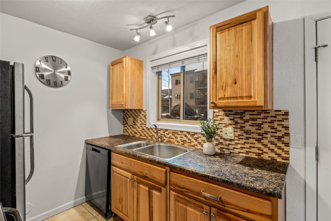 1565 Shadow Run Frontage, Unit B103 Steamboat Springs, CO 80487 - Photo 6 of 28 a bathroom with a sink a large mirror and a window