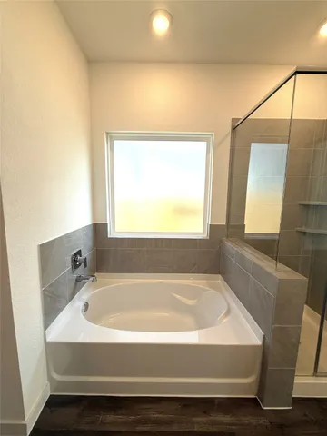 a white bath tub sitting next to a window