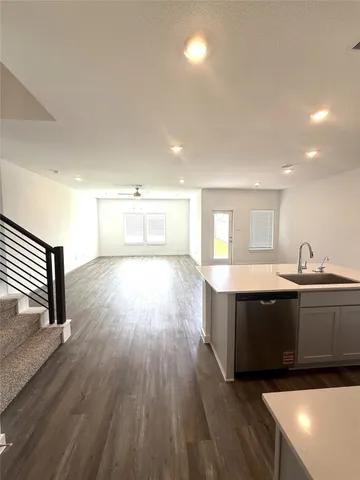 a view of kitchen with wooden floor and electronic appliances
