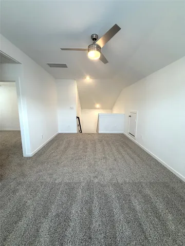 a view of a big room with wooden floor and windows