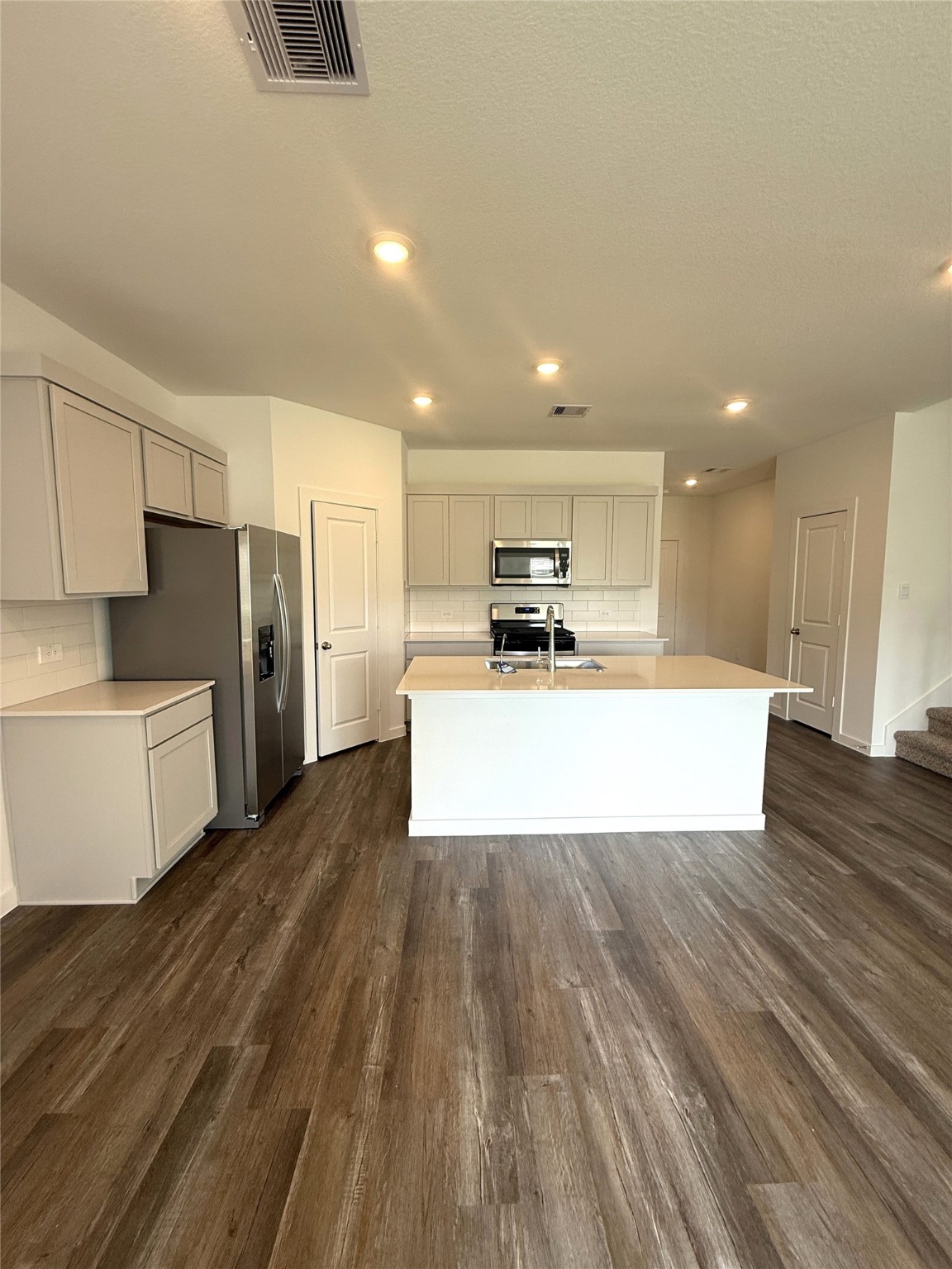 4308 Wallace Falls Lane Conroe, TX 77303 - Photo 5 of 27 a large kitchen with a center island stainless steel appliances and cabinets