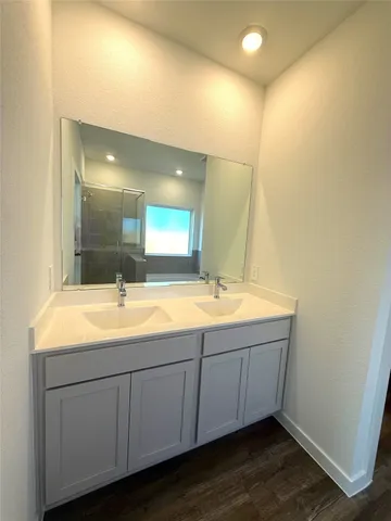 a bathroom with a double vanity sink and mirror