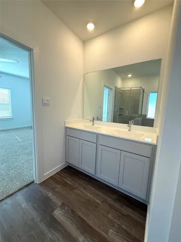 a bathroom with a double vanity sink and mirror