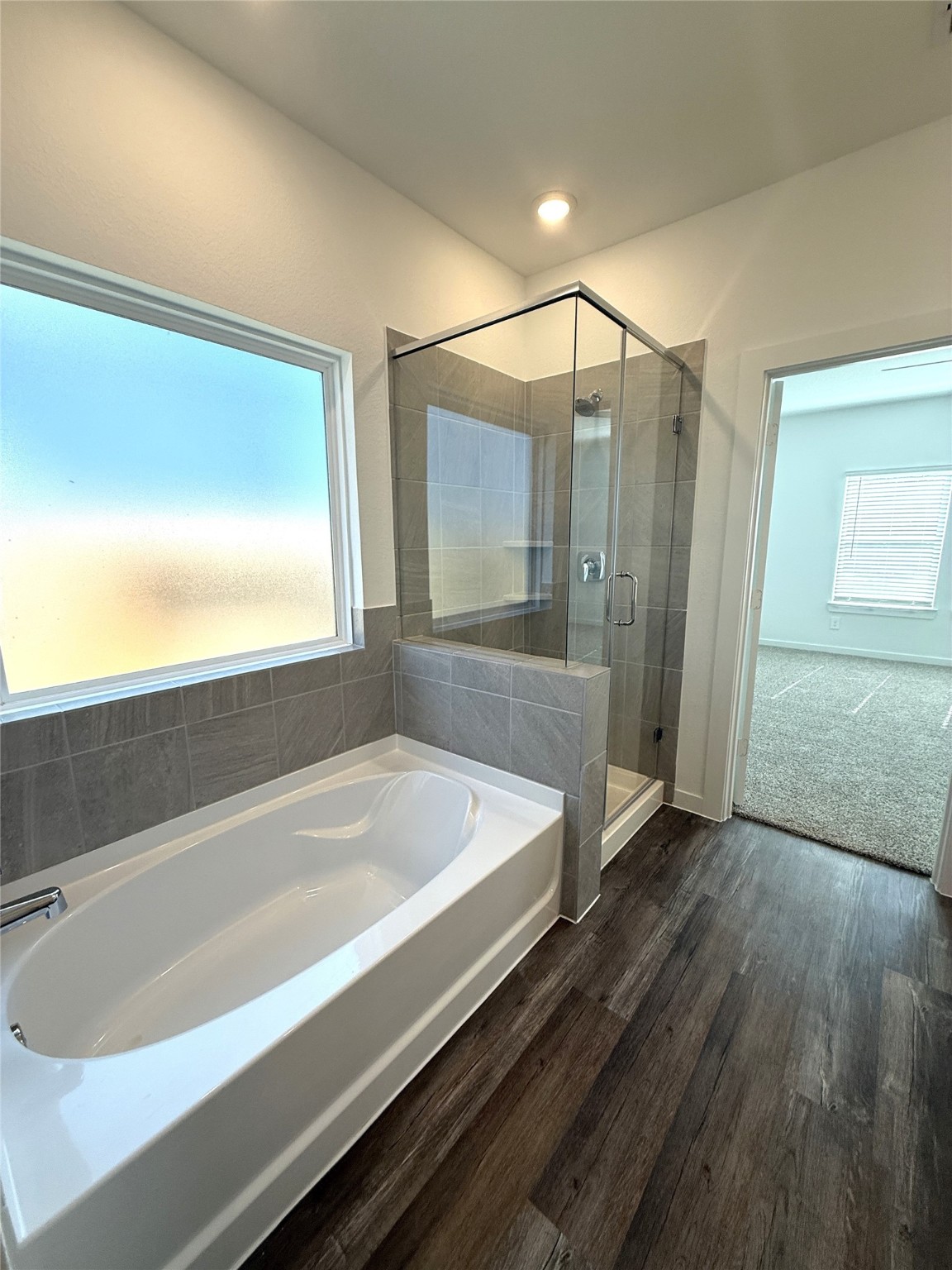 4308 Wallace Falls Lane Conroe, TX 77303 - Photo 10 of 27 a bathroom with a bathtub and a shower