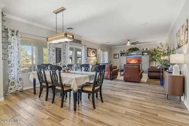 a living room with furniture a ceiling fan and a window