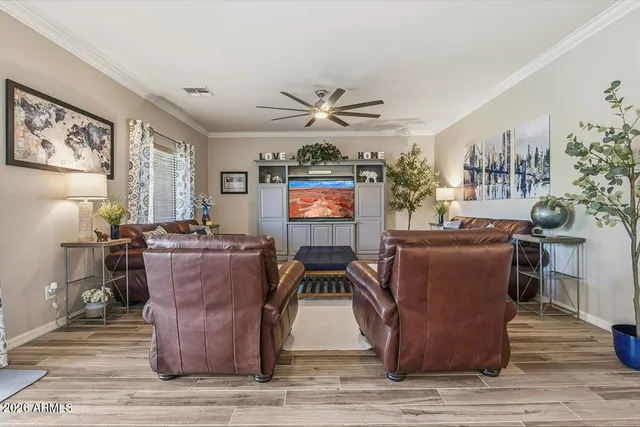 a living room with furniture a rug and a window
