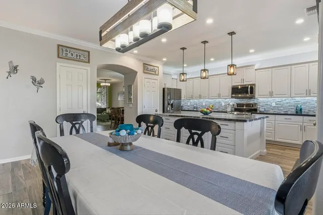 a kitchen with stainless steel appliances granite countertop a sink and a stove