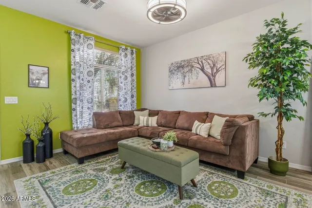 a spacious bedroom with a bed dresser and a potted plant