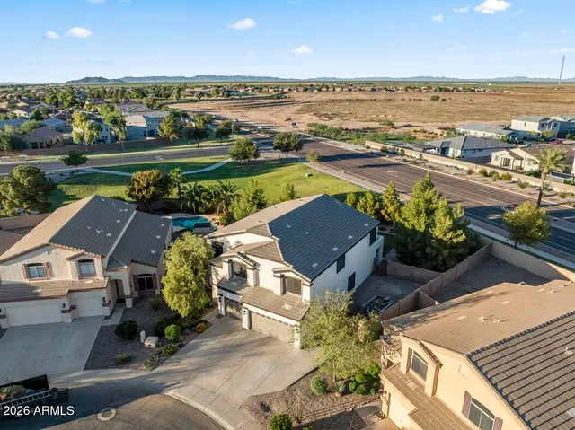 an aerial view of a house with a garden and outdoor seating