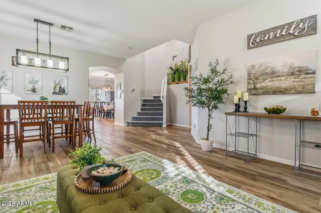 a bathroom with a sink a toilet a mirror and shower curtain