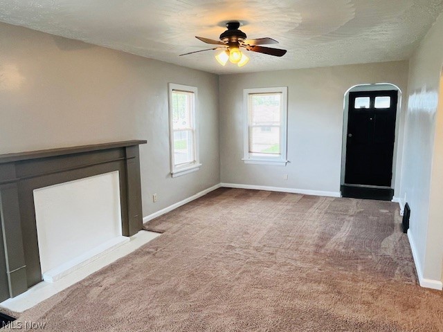 2918 9th Street Northwest Canton, OH 44708 - Photo 9 of 16 Unfurnished living room with carpet floors and ceiling fan