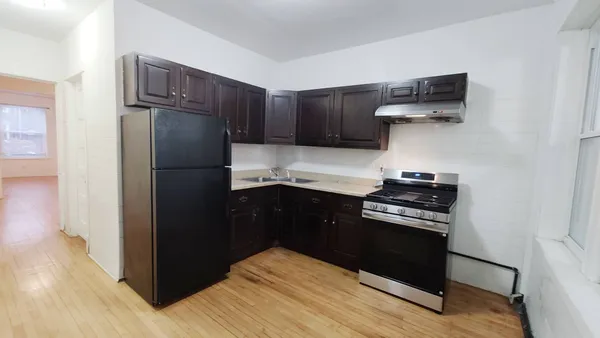 a kitchen with a refrigerator and a stove