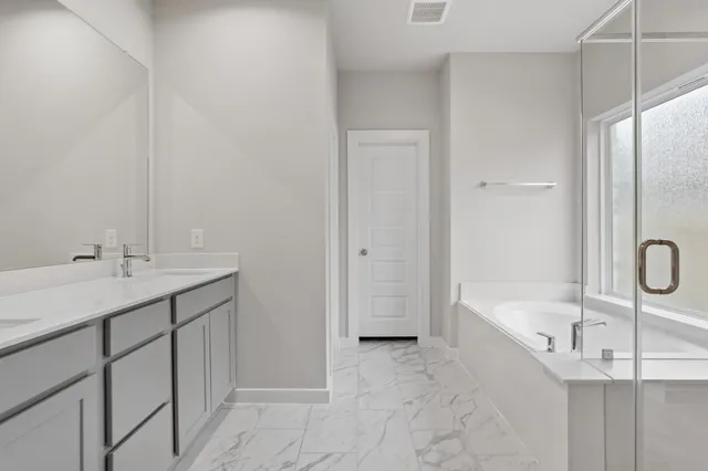 a bathroom with a tub sink and mirror