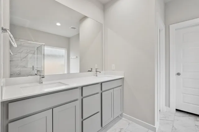 a bathroom with a sink double vanity and a mirror