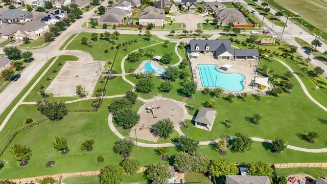 an aerial view of a house with swimming pool and outdoor seating