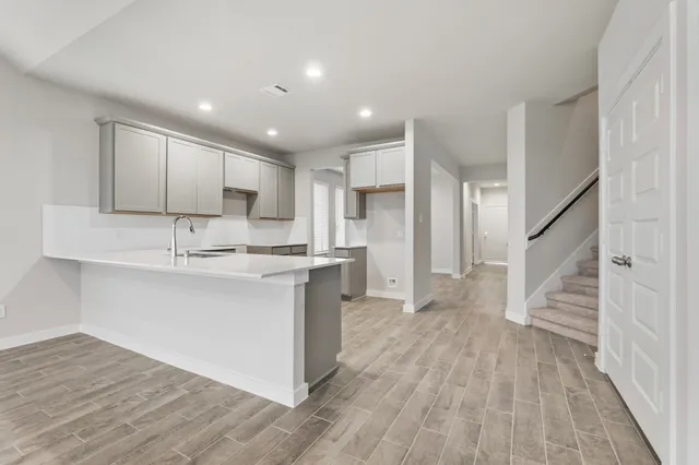 a view of kitchen with sink microwave and refrigerator