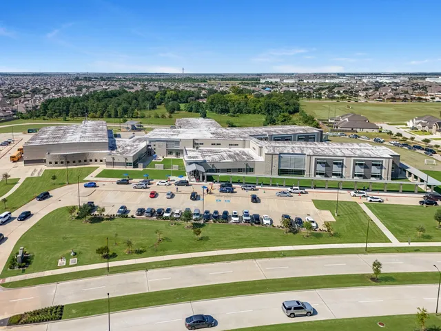 a front view of a house with a yard and potted plants