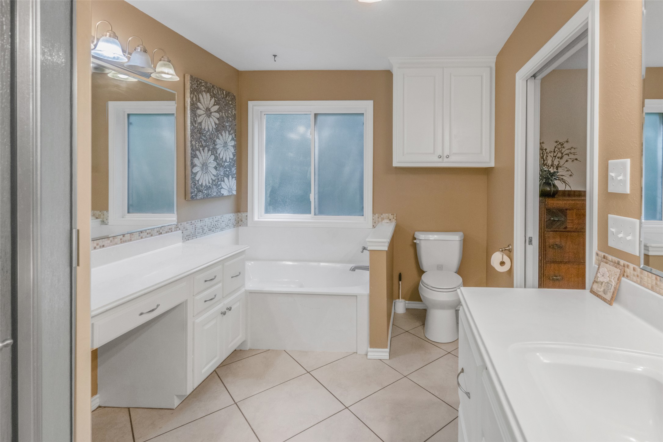 9997 Calhoun Road Bryan, TX 77808 - Photo 20 of 28 A spacious bathroom layout features a large soaking tub and tile flooring.