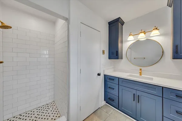 a bathroom with a sink a toilet and a mirror