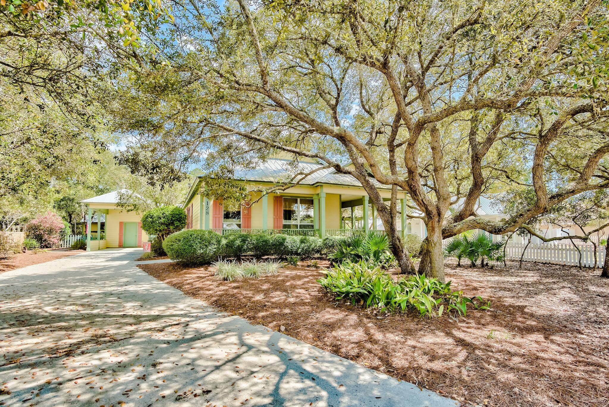 a front view of a house with a yard and potted plants