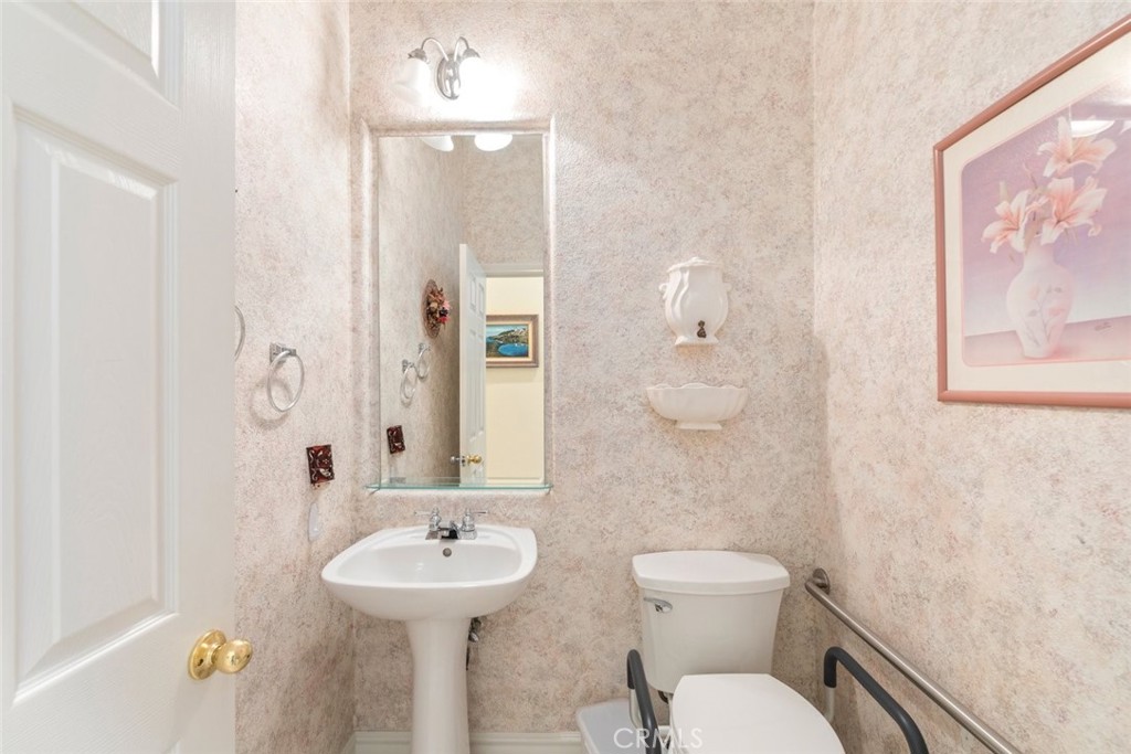 29546 Winding Brook Drive Menifee, CA 92584 - Photo 11 of 21 a bathroom with a sink mirror and toilet